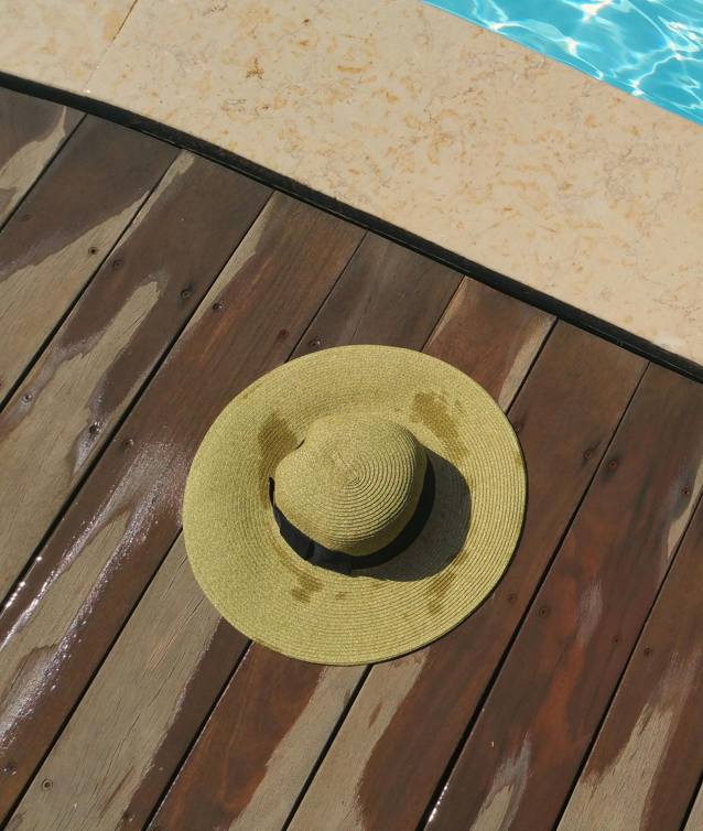 a hat resting on pool pavers